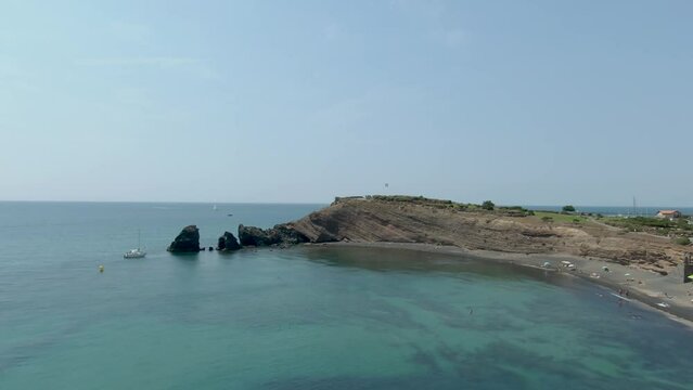 Aerial shooting black sand beach at Cap d'Agde. High quality 4k footage