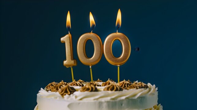 100th Gold Candles With Flames On A Cake Celebration