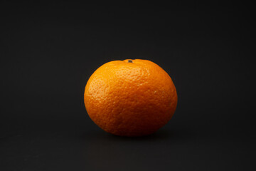 An fresh orange on black background