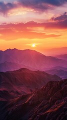 Obraz premium Mountain range during sunset with vibrant colors, panoramic view. Nature and tranquility concept