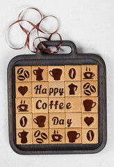 Modern Coffee square cookies with coffee marmalade filling in the form of drawings of a cup, a heart, a coffee pot, beans, words of a Happy coffee day. On a wooden plate. White background. Top view