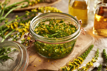 Preparation of herbal tincture from fresh agrimony flowers and leaves in a glass jar