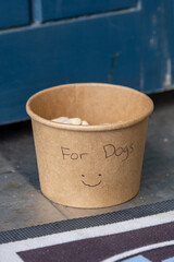 A container of dog biscuits at an outside cafe