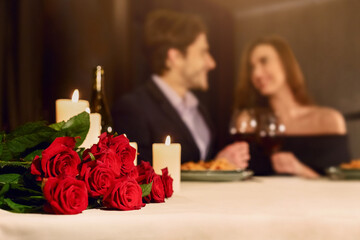 Loving couple in a restaurant celebrating Valentine day or anniversary. Romantic dinner for couple,...