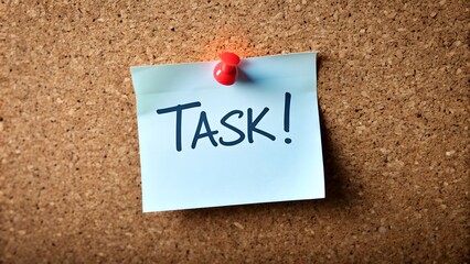 note pinned on a bulletin board with text 'task'