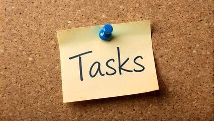 note pinned on a bulletin board with text 'task'