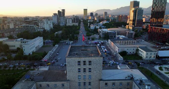Aerial view of Mother Theresa Square in Tirane Albania at sunset time showing the Albanian Flag at the top of University Building. 