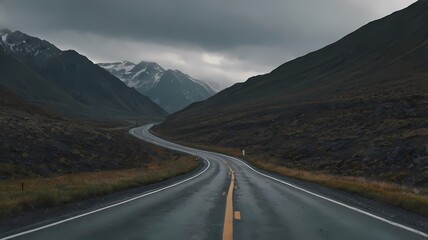Open Road Through Rugged Mountain Terrain Under Overcast