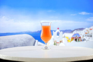 Fresh citrus fruit on wooden table top with beautiful summer landscape of calm sea and blue sky.