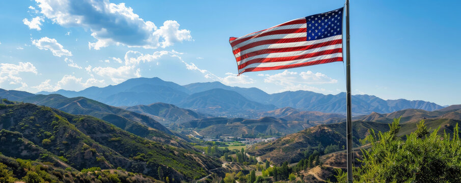 National Flag Day (USA) background with an American flag flying over a picturesque mountain range, with a backdrop of natural beauty, clear skies, and lush greenery.