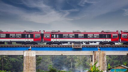View of a passenger train moving over a railway bridge
