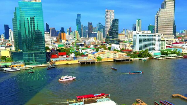 Chao Phraya River in BKK viewed from IconSiam Shopping Mall boats and ferries up and down the river and Bangkok high-rise buildings in the Background