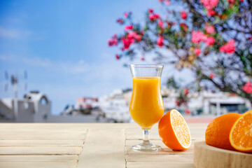 Fresh citrus fruit on wooden table top with beautiful summer landscape of calm sea and blue sky.
