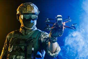 A soldier is depicted holding a drone while wearing stealth gear for military operations