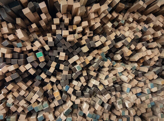 a stack of square sided wood sticks unevenly piled and protruding