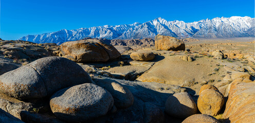 Rock Formations across The Valley Floor With Mt. Whitney and The Snow Capped Sierra Nevada Mountains, Alabama Hills National Scenic Area, California, USA