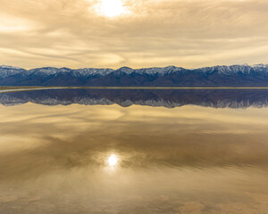 Sunset Reflections and The Sierra Nevada Mountains on The Flooded Salt Flats of Owens Lake, Lone Pine, California, USA