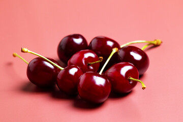 Sweet juicy cherries on a pink background