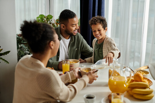 African american family enjoying meal together around table.