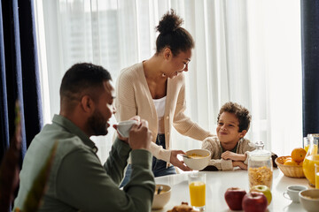 A loving African American family enjoying a meal together at a table.