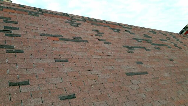 Roof in need of repair, missing shingles from storm damage