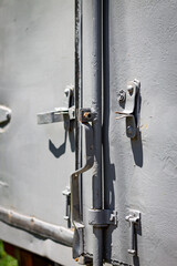 Color vertical photo, metal fastener close up old, metal, painted truck body close-up, transportation vehicle.