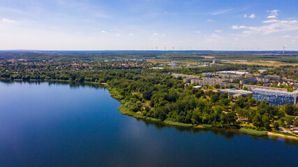 Aerial drone footage of a large, beautiful view of Senftenberg, a tourist town, sunny day.  beauty of German nature from air