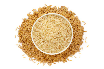 A bowl of Organic Rice (Oryza sativa), placed over a heap of Rice Bran (Dhaan in Hindi). Isolated on a white background.