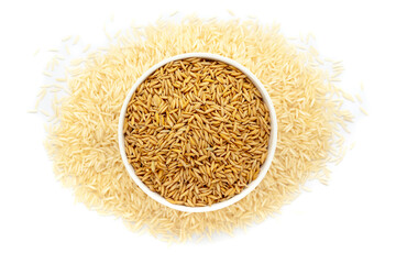 A bowl of Organic Rice Bran (Oryza sativa), placed over a heap of Rice. Isolated on a white background.