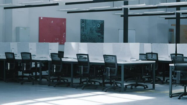 Modern empty coworking space interior with covered computers