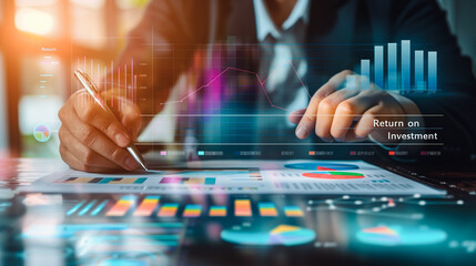  A business professional examines financial charts on a digital tablet, focusing on Return on Investment metrics, reflecting the integration of technology in strategic financial planning.