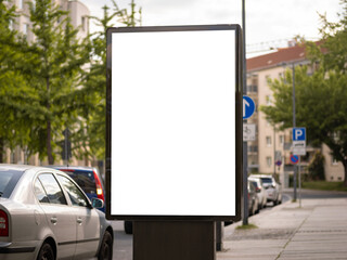 Billboard template space to test an advertisement placard. Vertical orientation of a poster. White box to insert an ad. An urban city area in Germany is in the background.