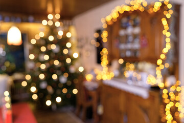 Blurred Section of Living Room Christmas Scene with Christmas Tree, Fairy Lights, Lamps and Candleli