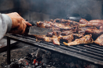 Argentinian asado made on the grill with different cuts of meat. Typical food of Argentina with beef and sausage.