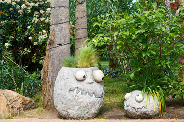 Decorative flower pot. Designer decoration of the pot. Flower beds.