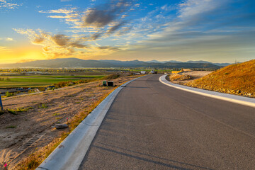 A new road along the beginnings of a hilltop view subdivision in Liberty Lake, Washington, looking over the cities of Spokane and Spokane Valley Washington.