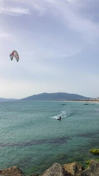 Enjoying kitesurfing on Valdevaqueros beach, Gibraltar Strait in Tarifa, Spain