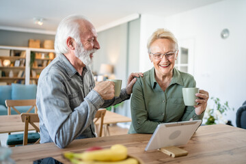 senior couple man woman husband wife have cup of coffee in the morning