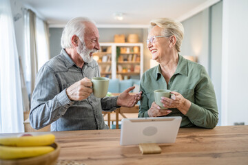 senior couple man woman husband wife have cup of coffee in the morning