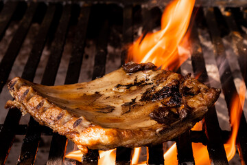 Juicy grilled pork chop over open flame