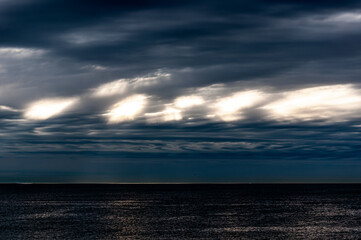 Obraz premium Seascape. Stormy sky over the sea on an autumn morning. Strange cloud formations.