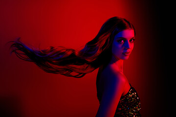 Profile photo of gorgeous young lady flying hair wear dress isolated on red blue color neon...