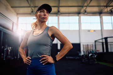 Portrait of confident athletic woman in  gym looking away.