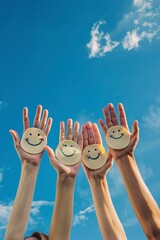 Happy people with smiley on hands against blue summer