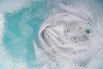 White cloth soaked in powder detergent water dissolution, washing cloth. Laundry concept