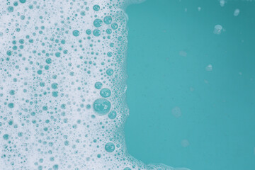 Detergent foam bubble on water. Blue background, Soap sud