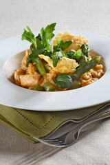 Asparagus risotto with pirarucu and fried cassava chips