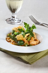 Asparagus risotto with pirarucu and fried cassava chips