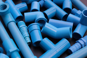 Obraz premium Plumber equipment with blue pvc pipe connections for plumbing work.