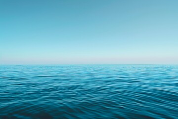 A serene view of a calm ocean under a clear blue sky